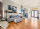 Open-concept living room with a gray sofa and wood floors at 1319 Johns Cove Ln, Oakland, FL 34787