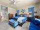 Spacious bedroom with a king-sized bed, ceiling fan, and blue accents at 1319 Johns Cove Ln, Oakland, FL 34787