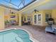 Inviting pool area with outdoor seating, brick pavers, and a covered patio at 1319 Johns Cove Ln, Oakland, FL 34787
