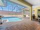 Screened-in pool area with brick pavers, outdoor seating, and a view of the backyard at 1319 Johns Cove Ln, Oakland, FL 34787