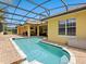 Beautiful screened-in pool with brick pavers, complemented by lush landscaping at 1319 Johns Cove Ln, Oakland, FL 34787
