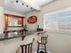 A stylish wet bar with granite countertop, mirror, shelving, and seating at 1319 Johns Cove Ln, Oakland, FL 34787
