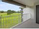 Relaxing balcony view with a golf course, lake, and blue skies at 13917 Fairway Island Dr # 931, Orlando, FL 32837