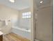 Well-lit bathroom featuring a tub, a shower, and wood look flooring at 13917 Fairway Island Dr # 931, Orlando, FL 32837