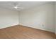 Empty bedroom with laminate floors featuring a ceiling fan at 13917 Fairway Island Dr # 931, Orlando, FL 32837
