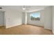 Empty bedroom featuring light walls, wood floors, and large window at 13917 Fairway Island Dr # 931, Orlando, FL 32837