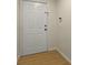Clean entryway featuring a secure white door and modern hardwood flooring, offering a fresh welcome at 13917 Fairway Island Dr # 931, Orlando, FL 32837