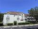 A condominium building with multiple parking spaces available and beautiful landscape around the building at 13917 Fairway Island Dr # 931, Orlando, FL 32837