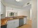 Bright kitchen with butcher block countertops and stainless steel dishwasher at 13917 Fairway Island Dr # 931, Orlando, FL 32837