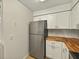 Modern kitchen with stainless steel refrigerator and butcher block counters at 13917 Fairway Island Dr # 931, Orlando, FL 32837