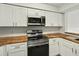 Well-equipped kitchen with stainless steel appliances and butcher block counters at 13917 Fairway Island Dr # 931, Orlando, FL 32837