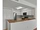 Kitchen featuring butcher block countertops and stainless steel appliances with white cabinetry at 13917 Fairway Island Dr # 931, Orlando, FL 32837