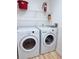 A spacious laundry room featuring a washer, a dryer and shelves for organizing your detergent at 13917 Fairway Island Dr # 931, Orlando, FL 32837