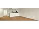 Bright, open living space with kitchen view and wood laminate flooring at 13917 Fairway Island Dr # 931, Orlando, FL 32837
