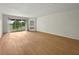 Open living space with wood flooring and a sliding door to the balcony at 13917 Fairway Island Dr # 931, Orlando, FL 32837