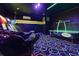 Cool arcade room with neon lights and several arcade games for hours of fun and entertainment at 1403 Rolling Fairway Dr, Davenport, FL 33896