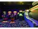 Arcade room featuring several gaming options with black walls, perfect for indoor entertainment at 1403 Rolling Fairway Dr, Davenport, FL 33896