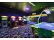 Fun-filled arcade room with classic arcade games, and a unique neon carpet at 1403 Rolling Fairway Dr, Davenport, FL 33896