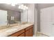 Bright bathroom features double sinks, granite countertops, and a large mirror at 1403 Rolling Fairway Dr, Davenport, FL 33896