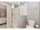 Bathroom showcasing a glass enclosed shower, toilet, and a view into an adjacent bedroom at 1403 Rolling Fairway Dr, Davenport, FL 33896