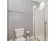 Bathroom featuring tiled walk-in shower with glass door, white toilet, and towel rack at 1403 Rolling Fairway Dr, Davenport, FL 33896