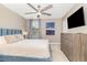 Bedroom features a comfortable bed, ceiling fan, and modern artwork at 1403 Rolling Fairway Dr, Davenport, FL 33896