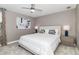 Bedroom features a comfortable bed, ceiling fan, and modern artwork at 1403 Rolling Fairway Dr, Davenport, FL 33896