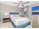 This bedroom is furnished with a modern bed, ceiling fan, and unique end tables at 1403 Rolling Fairway Dr, Davenport, FL 33896