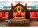 Themed bedroom features a beautifully decorated tiki hut bed frame with warm lighting at 1403 Rolling Fairway Dr, Davenport, FL 33896