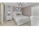 Bedroom with a queen bed, side table with lamp, ceiling fan, and carpet flooring at 1403 Rolling Fairway Dr, Davenport, FL 33896