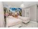 Charming ' bedroom featuring twin beds with princess carriage headboards and a colorful Disney themed mural at 1403 Rolling Fairway Dr, Davenport, FL 33896