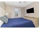Bedroom features a blue accent pillows, dresser, and a TV at 1403 Rolling Fairway Dr, Davenport, FL 33896