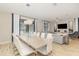 Open-concept dining area with a large table, chandelier, and seamless flow to the living room and backyard at 1403 Rolling Fairway Dr, Davenport, FL 33896