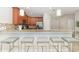 Modern kitchen with granite countertops, stainless steel appliances, and bar seating for casual dining at 1403 Rolling Fairway Dr, Davenport, FL 33896