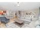 Bright and airy living room featuring stylish decor, comfortable seating, and an adjacent dining area for entertaining at 1403 Rolling Fairway Dr, Davenport, FL 33896