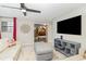 Upstairs living room features an accent mirror, couch, and a door to another bedroom at 1403 Rolling Fairway Dr, Davenport, FL 33896