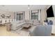 Spacious living room featuring modern furniture, tile floors, and sliding glass doors leading to an outdoor area at 1403 Rolling Fairway Dr, Davenport, FL 33896