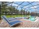 Relaxing screened-in pool area with lounge chairs, perfect for outdoor entertaining and enjoying the Florida sunshine at 1403 Rolling Fairway Dr, Davenport, FL 33896