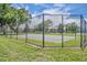 Fenced basketball court in a green community area, offering a fun recreational space for residents at 141 Reserve Cir # 113, Oviedo, FL 32765