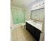 Bathroom with updated vanity, toilet, and shower with green curtain at 141 Reserve Cir # 113, Oviedo, FL 32765