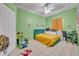 Bright bedroom with unique decor, desk, and tiled flooring, featuring a ceiling fan at 141 Reserve Cir # 113, Oviedo, FL 32765