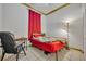 Bedroom with red accents featuring a bed, desk, tile flooring, and floor lamp at 141 Reserve Cir # 113, Oviedo, FL 32765