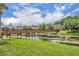 Picturesque bridge across a pond leading to beautiful residential buildings, set against a backdrop of lush greenery at 141 Reserve Cir # 113, Oviedo, FL 32765