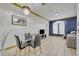 Dining area with modern chandelier, glass table, and comfortable seating, adjacent to living room at 141 Reserve Cir # 113, Oviedo, FL 32765