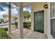 Inviting condo front door, number 113, with classic white columns, and a serene garden view at 141 Reserve Cir # 113, Oviedo, FL 32765