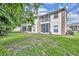 Exterior view of building, showcasing the lawn, mature trees and screened porches at 141 Reserve Cir # 113, Oviedo, FL 32765