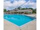 Community pool with clear blue water, lounge chairs, and a shaded picnic area at 141 Reserve Cir # 113, Oviedo, FL 32765
