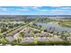 A picturesque aerial view of townhomes next to a body of water in a manicured community at 15241 Sunrise Grove Ct, Winter Garden, FL 34787