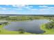 Expansive aerial view showcasing a community near a lake and golf course on a bright, sunny day at 15241 Sunrise Grove Ct, Winter Garden, FL 34787