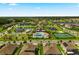 An aerial view of a community featuring a pool, tennis courts, ponds and beautiful landscaping at 15241 Sunrise Grove Ct, Winter Garden, FL 34787